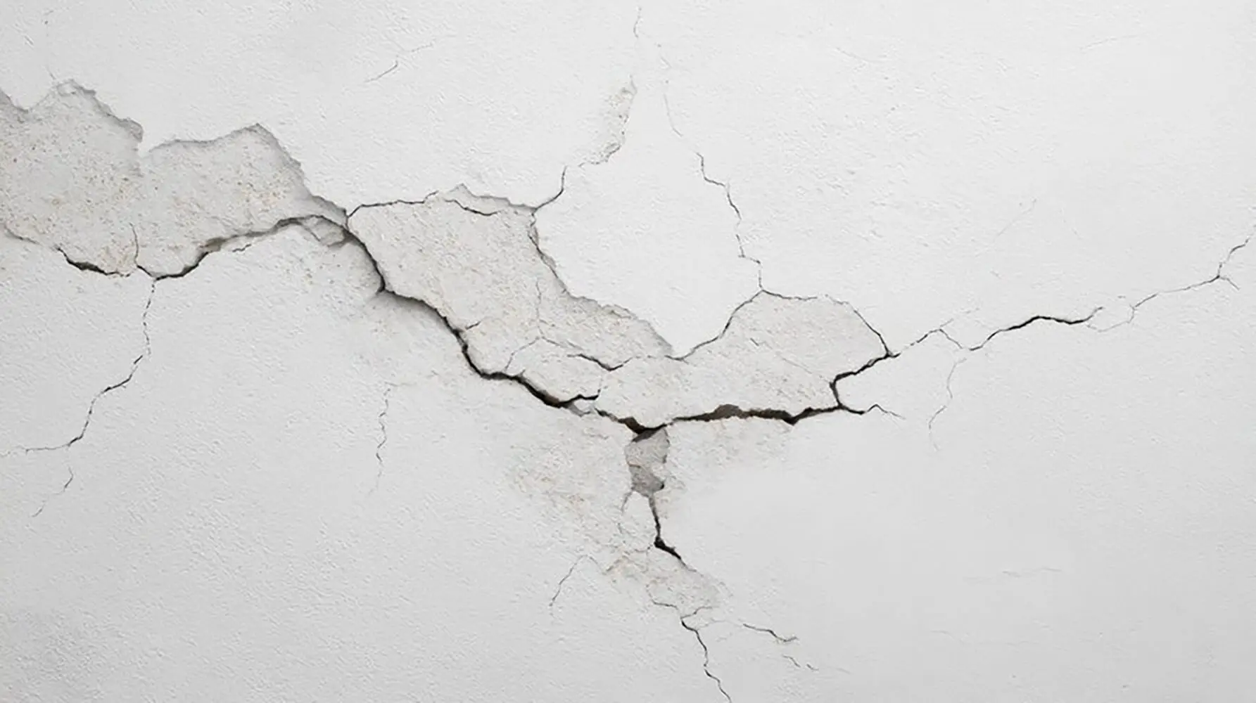 Cracked interior wall showing damage that leads to interior painting mistakes that cost homeowners money