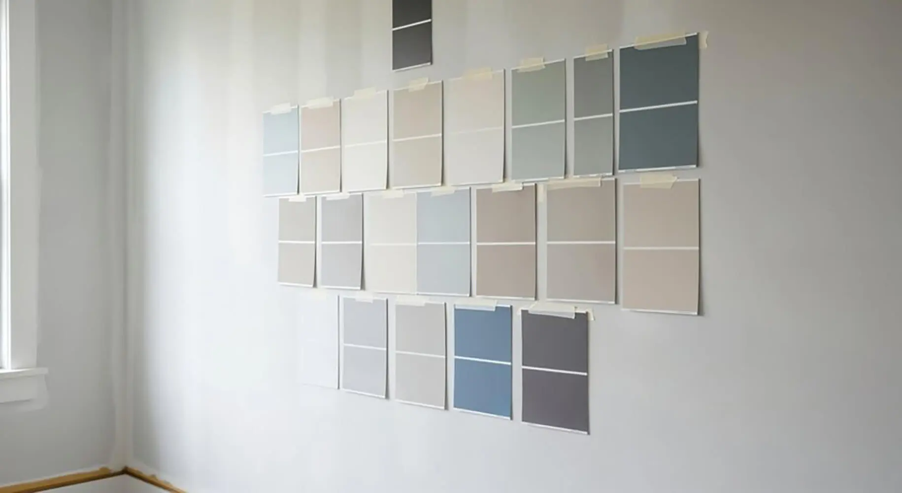Interior paint color samples on a wall showing interior paint colors that make cold rooms feel warmer through soft neutrals and warm undertones