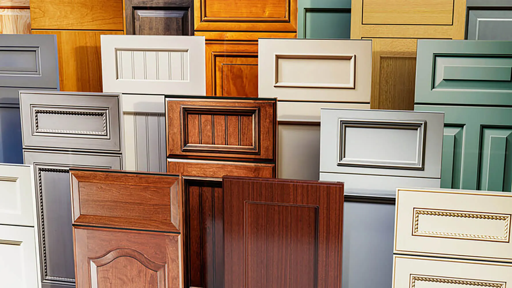 Popular cabinet styles for kitchens in Grand Rapids shown through a variety of painted and stained cabinet door designs, including shaker, raised panel, and modern flat-panel styles displayed side by side.