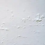 how humid weather affects interior paint causing bubbling and surface defects on an interior wall