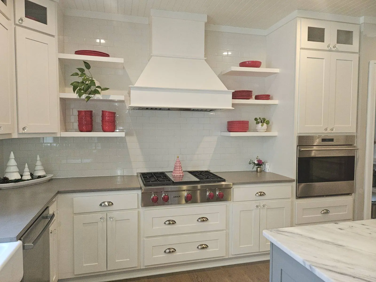 White shaker kitchen cabinets and range wall before cabinet refacing in Ada MI