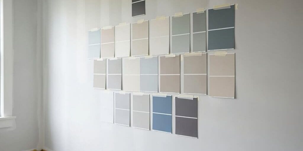 Interior paint color samples on a wall showing interior paint colors that make cold rooms feel warmer through soft neutrals and warm undertones